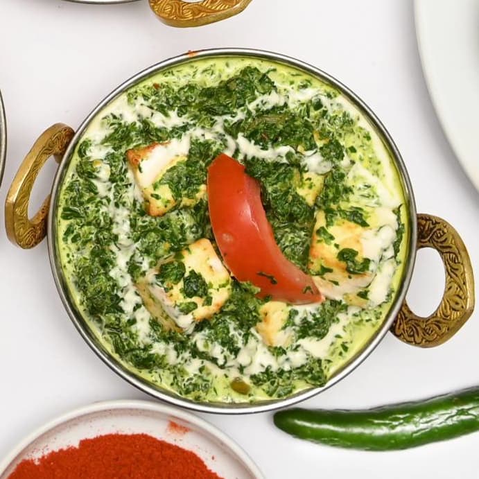 Palak paneer with fresh tomato in a creamy spinach sauce