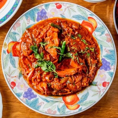 Slow-cooked lamb curry with tomatoes and fresh herbs